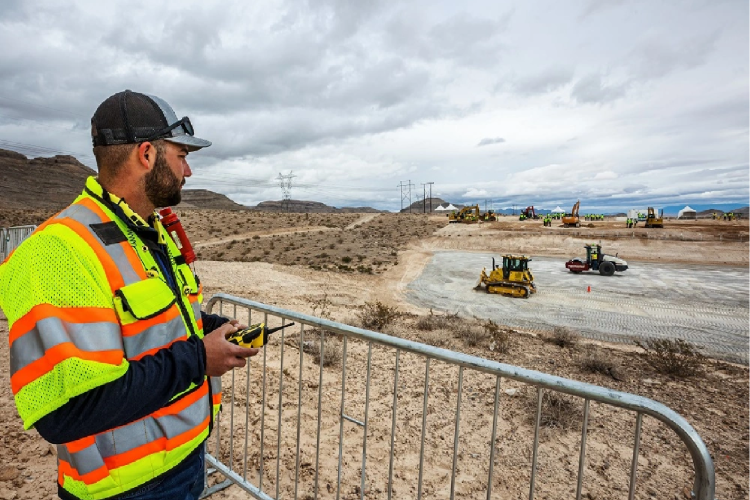 Trimble employee remotely controls a dozer at Dimensions 2022+ -- reflecting the industry's increased investment in autonmous technology solutions.